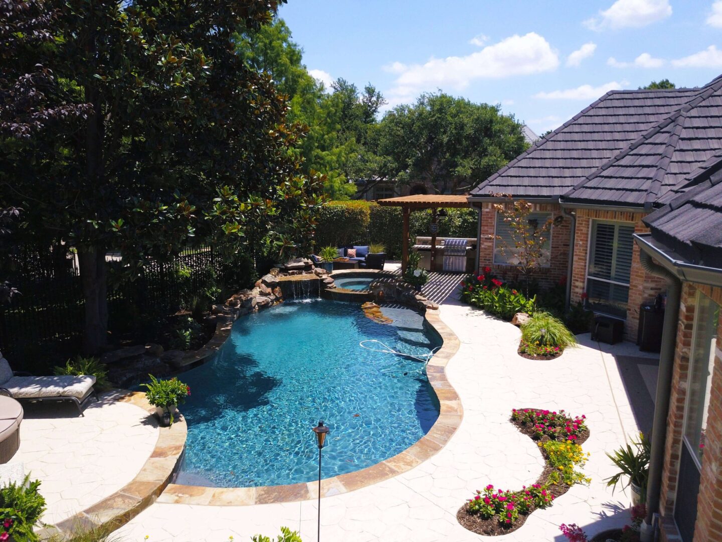 A pool with a large patio area and a gazebo.