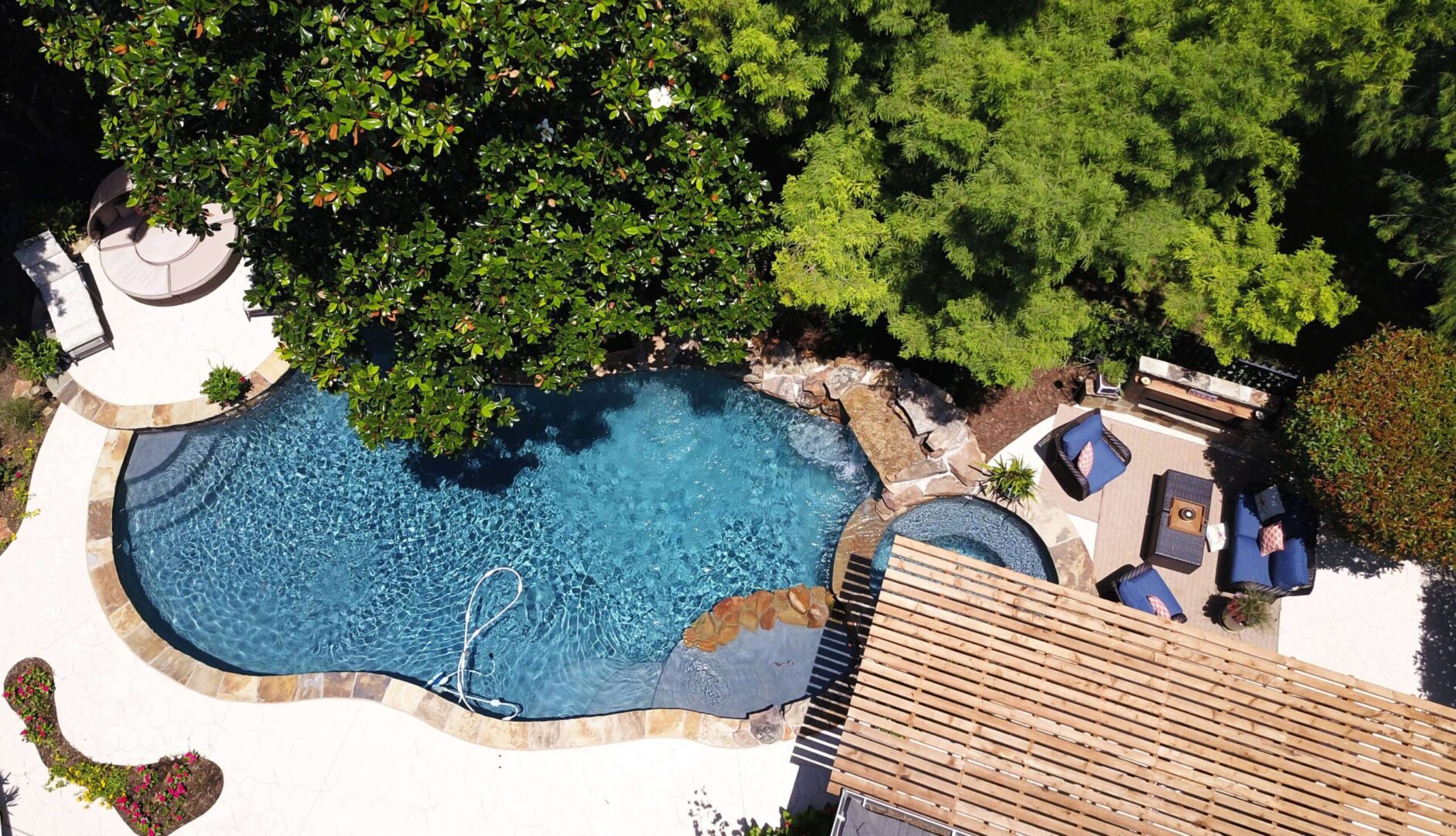 A pool with a wooden deck and trees