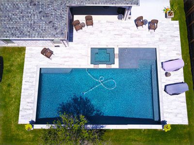 A pool with an aerial view of the backyard.